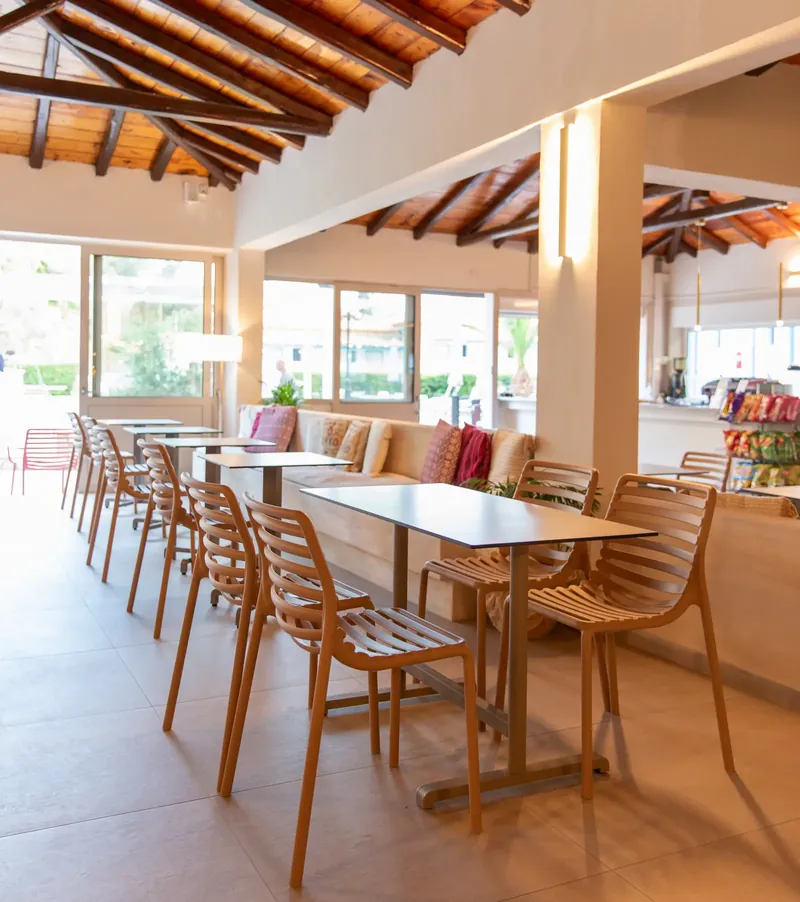 Wooden chairs and tables by the lobby windows