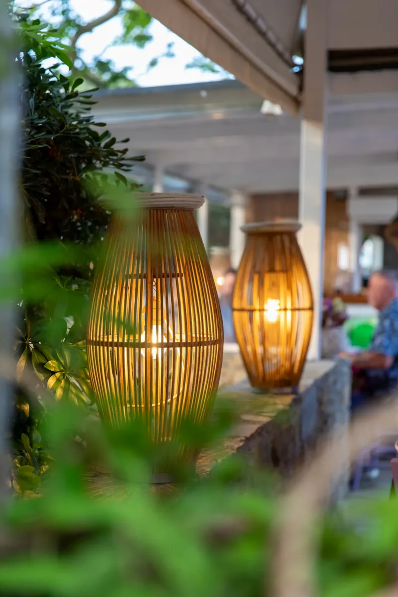 Woven lanterns hanging over the tables