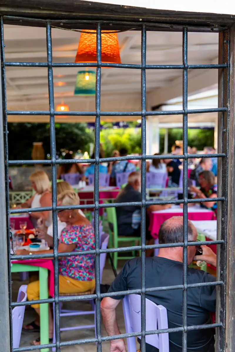 The terrace seen through a window grille