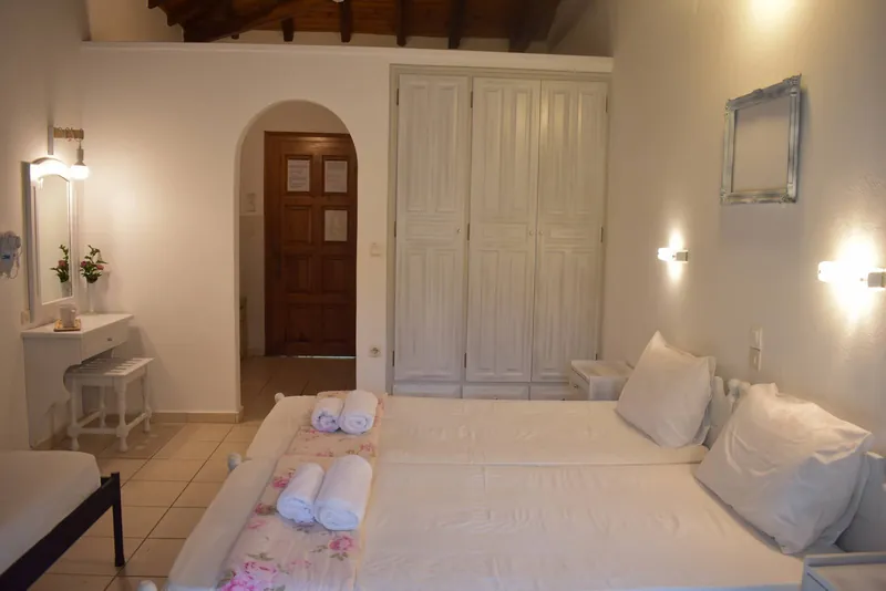 A bright room with an arched doorway and wardrobes