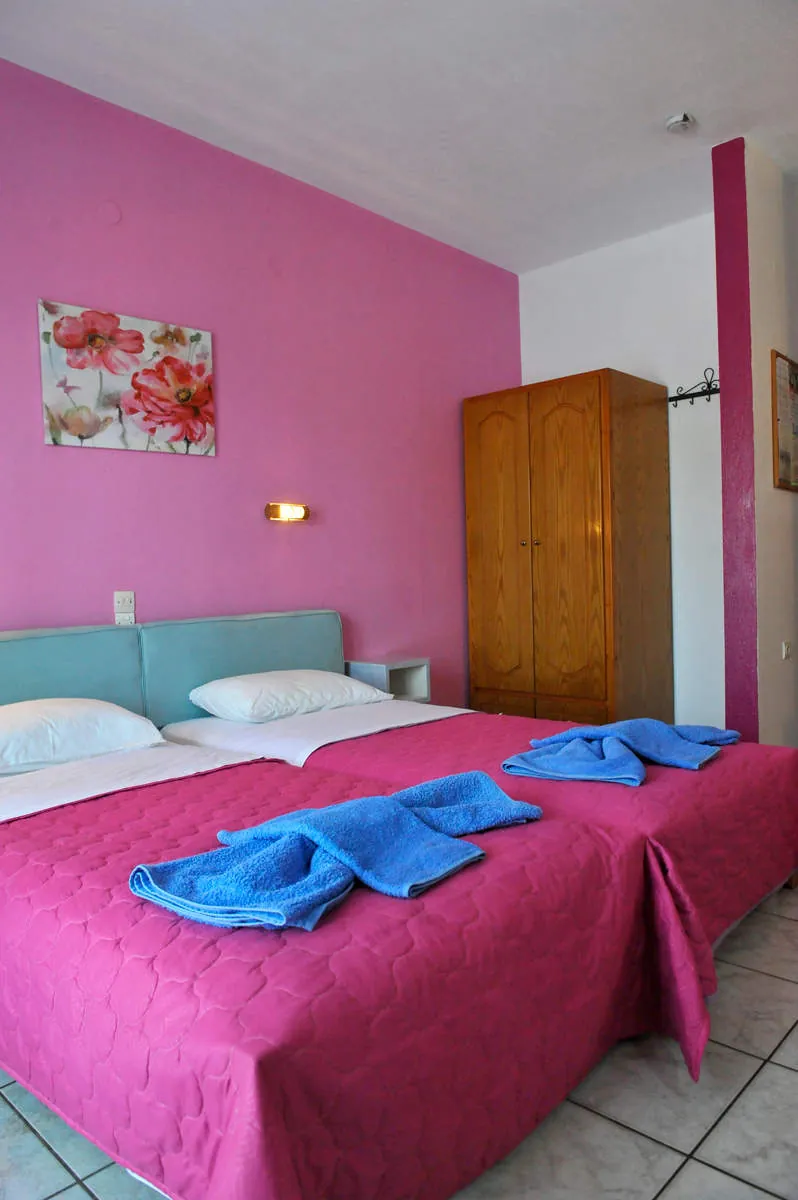 Twin beds and a wooden wardrobe